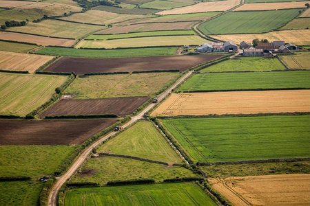 An image of the word agrarian as defined by relating to land, land tenure, or the division of landed property.