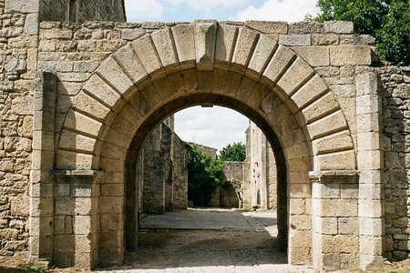 An image of the word arch as defined by a curved masonry construction for spanning an opening, consisting of a number of wedgelike stones, bricks, or the like, set with the narrower side toward the opening in such a way that forces on the arch are transmitted as vertical or oblique stresses on either side of the opening.