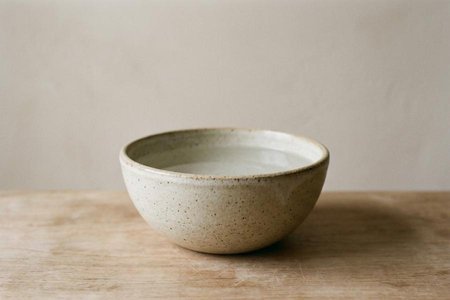 An image of the word bowl as defined by a rather deep, round dish or basin, used chiefly for holding liquids, food, etc.