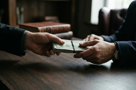 An image of the word bribe as defined by money or any other valuable consideration given or promised with a view to corrupting the behavior of a person, especially in that person's performance as an athlete, public official, etc..