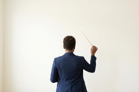 An image of the word conductor as defined by a person who conducts; a leader, guide, director, or manager.