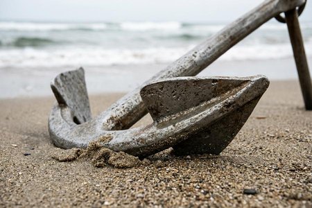 An image of the word fluke as defined by the part of an anchor that catches in the ground, especially the flat triangular piece at the end of each arm.