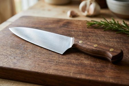 An image of the word knife as defined by an instrument for cutting, consisting essentially of a thin, sharp-edged, metal blade fitted with a handle.