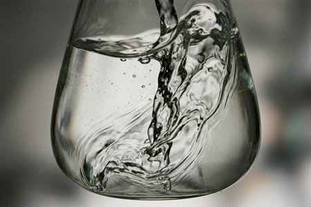 An image of the word liquid as defined by composed of molecules that move freely among themselves but do not tend to separate like those of gases; neither gaseous nor solid.