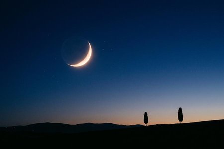 An image of the word night as defined by the period of darkness between sunset and sunrise.
