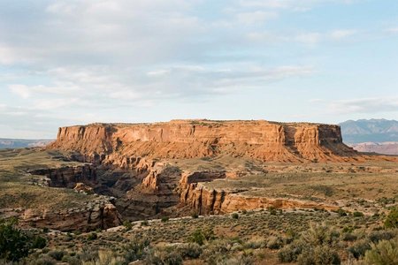 An image of the word plateau as defined by a land area having a relatively level surface considerably raised above adjoining land on at least one side, and often cut by deep canyons.