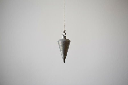 An image of the word plummet as defined by a piece of lead or some other weight attached to a line, used for determining perpendicularity, for sounding, etc.; the bob of a plumb line.