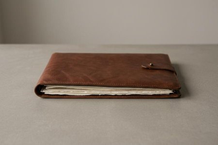 An image of the word portfolio as defined by a flat, portable case for carrying loose papers, drawings, etc.