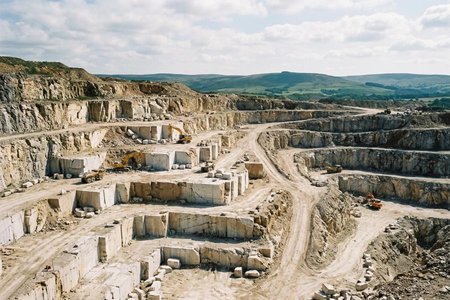 An image of the word quarry as defined by an excavation or pit, usually open to the air, from which building stone, slate, or the like, is obtained by cutting, blasting, etc.