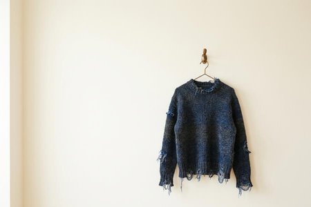 An image of the word ragged as defined by clothed in tattered garments.