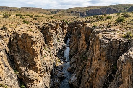 An image of the word ravine as defined by a narrow steep-sided valley commonly eroded by running water.