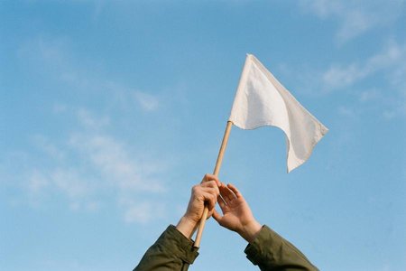 An image of the word surrender as defined by to yield (something) to the possession or power of another; deliver up possession of on demand or under duress.