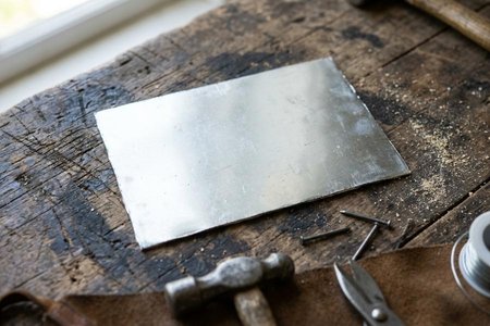 An image of the word tain as defined by a thin tin plate.